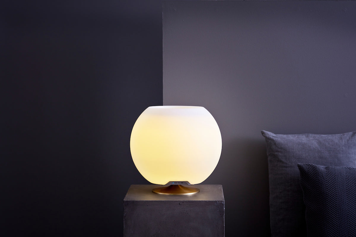 Kooduu Sphere lamp in round design illuminating a modern dark interior