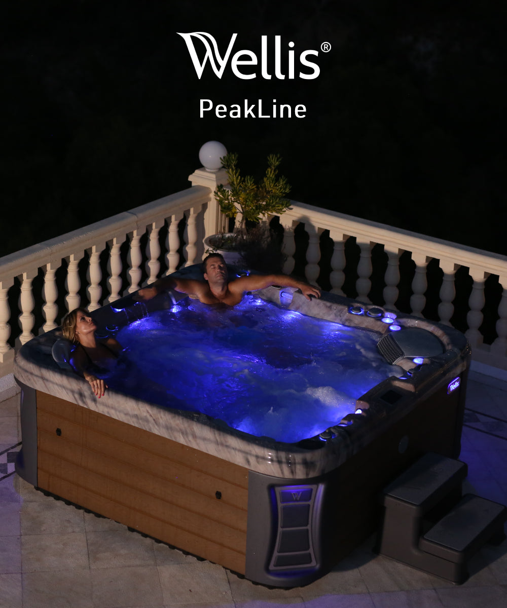 Couple relaxing on balcony in hot tub with underwater blue light