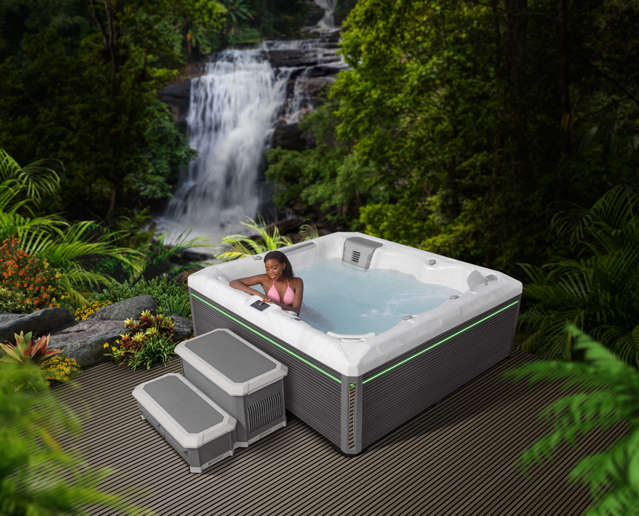 A woman in the energy-saving Wellis hot tub on terrace with a big waterfall in the background